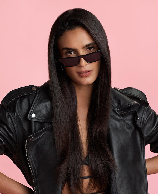 a woman wearing sunglasses and a leather jacket