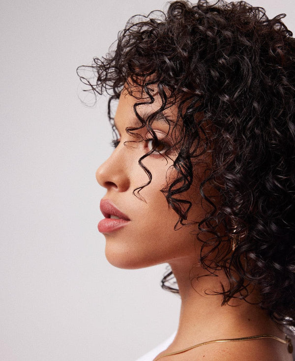 a profile of a woman with curly hair