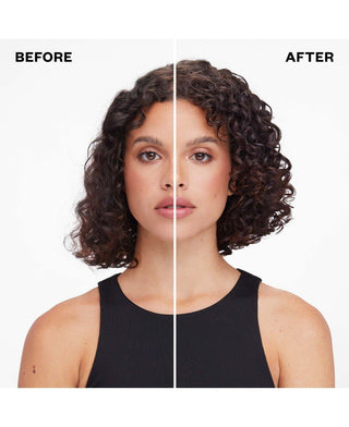 a woman with curly hair and a black tank top