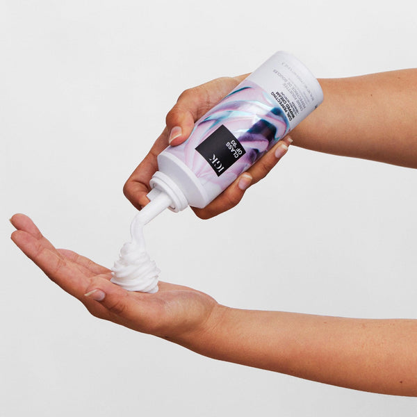 a person's hand with a white tube of foam
