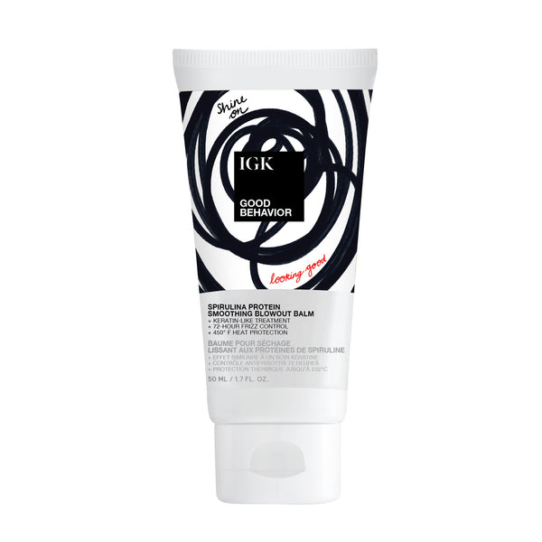 Bottle of IGK Good Behavior Smoothing Blowout Balm, featuring a bold black spiral design.