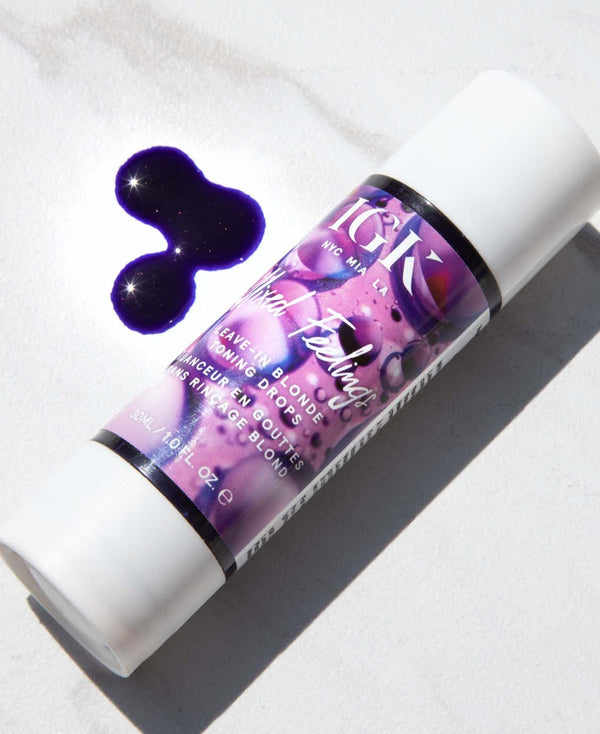 a purple and white container with a blot of purple liquid